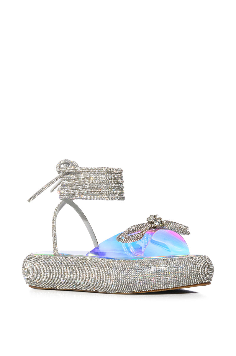 OUTSHINE EMBELLISHED BOW LACE UP FLAT SANDAL IN HOLO