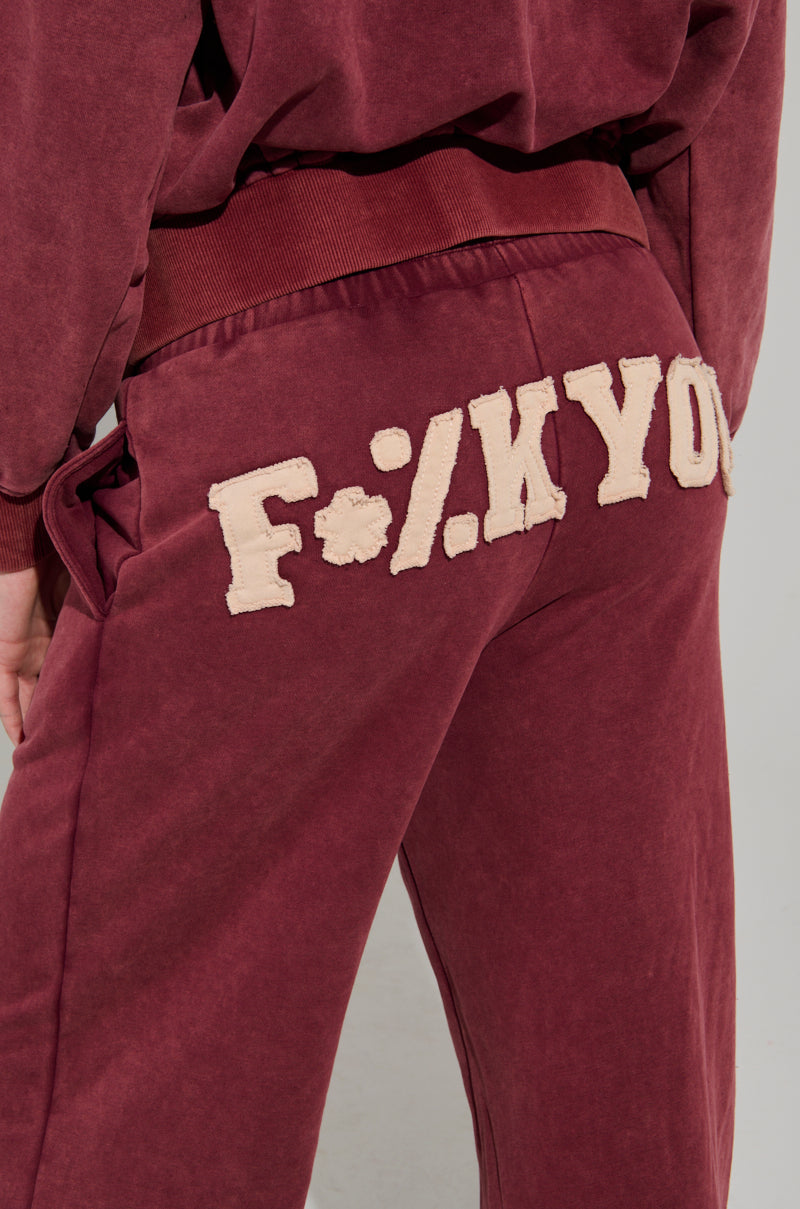 GRAPHIC LANGUAGE MINERAL WASH SWEAT PANT IN BURGUNDY